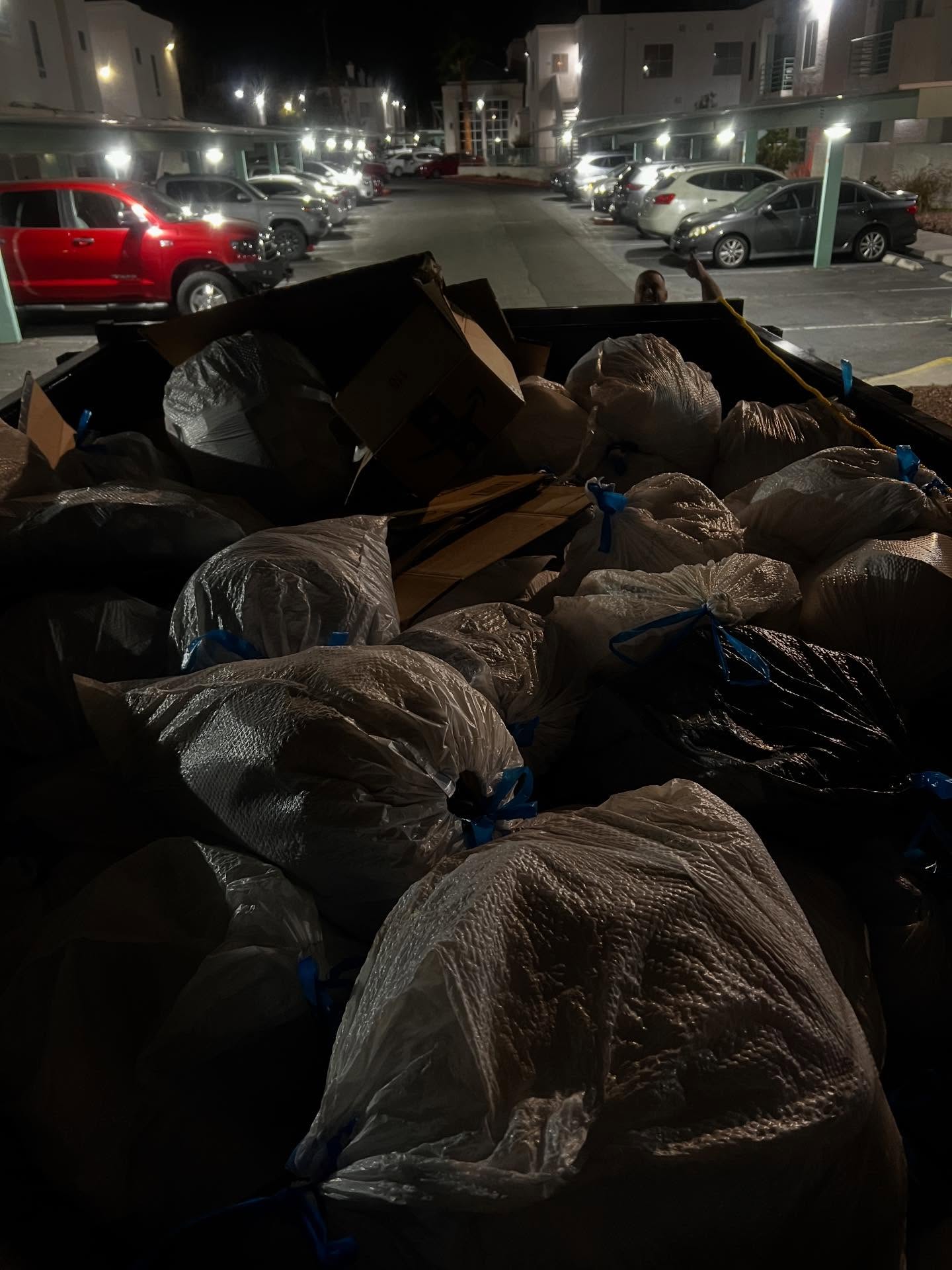 An LWP Hauling trailer loaded with bagged junk after a same-day cleanout job